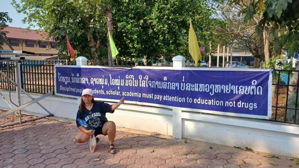 Yulli in front of a school in Thakhek