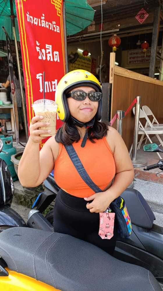 Yulli is holding one cup of coffee