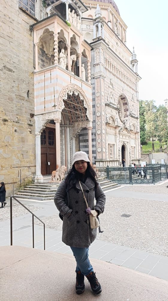 A woman standing in front of a church