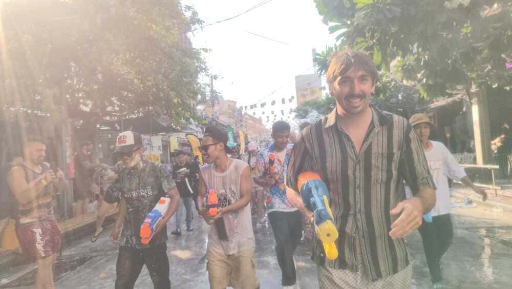 Crowd with water guns pointed at camera